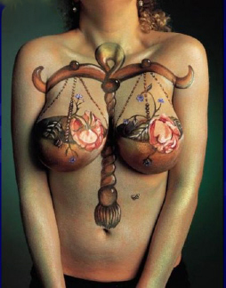 Peinture sur corps: une balance peinte autour d'une poitrine de femme